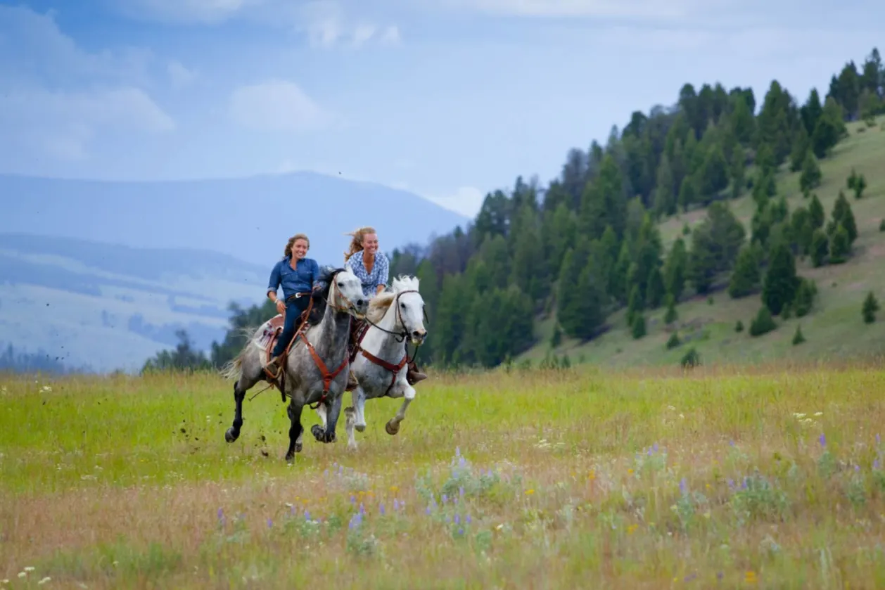 Two horseback riding women at ranch rock creek fitness holiday